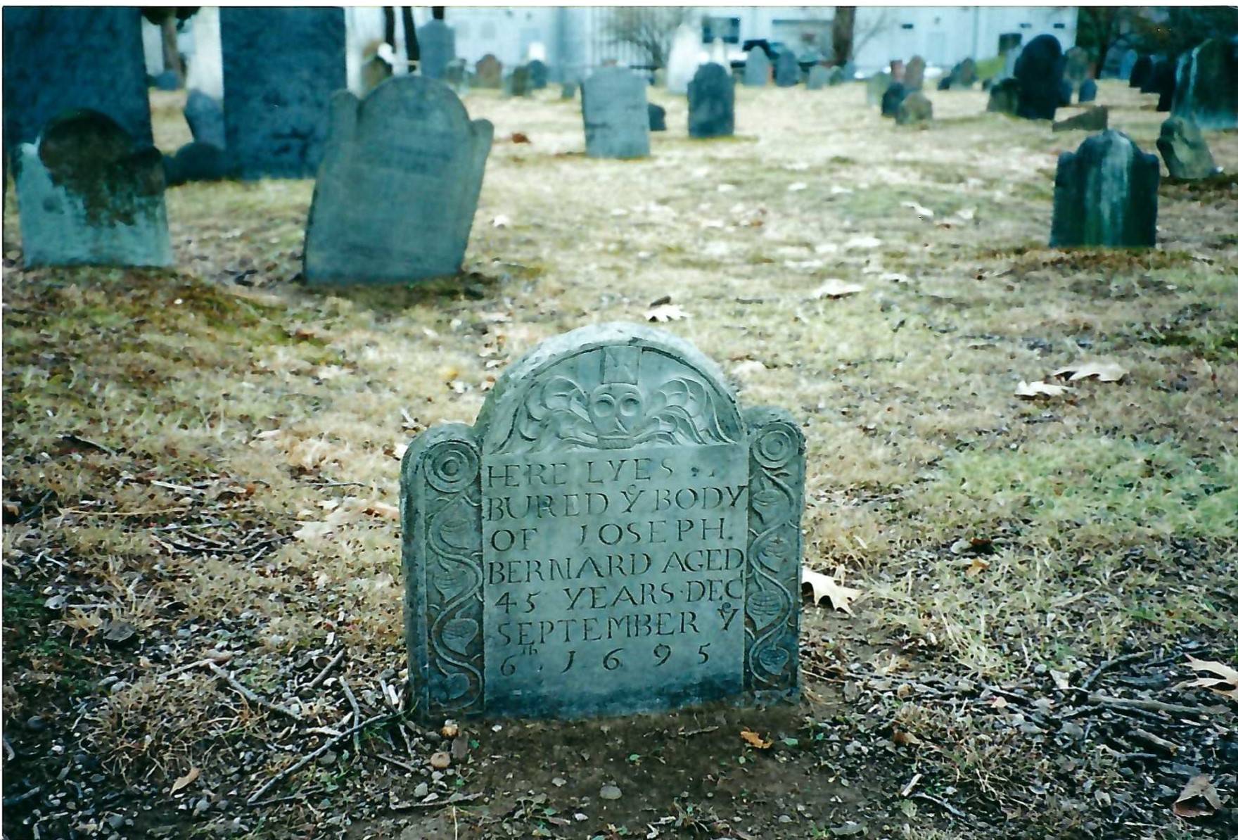 Since the seventeenth century, many grave markers have become illegible due to weather or other damage. The gravestone in foreground reads “Here lyes buried the body of Joseph Bernard, aged 45 years, dec [deceased] September 6th 1695.”