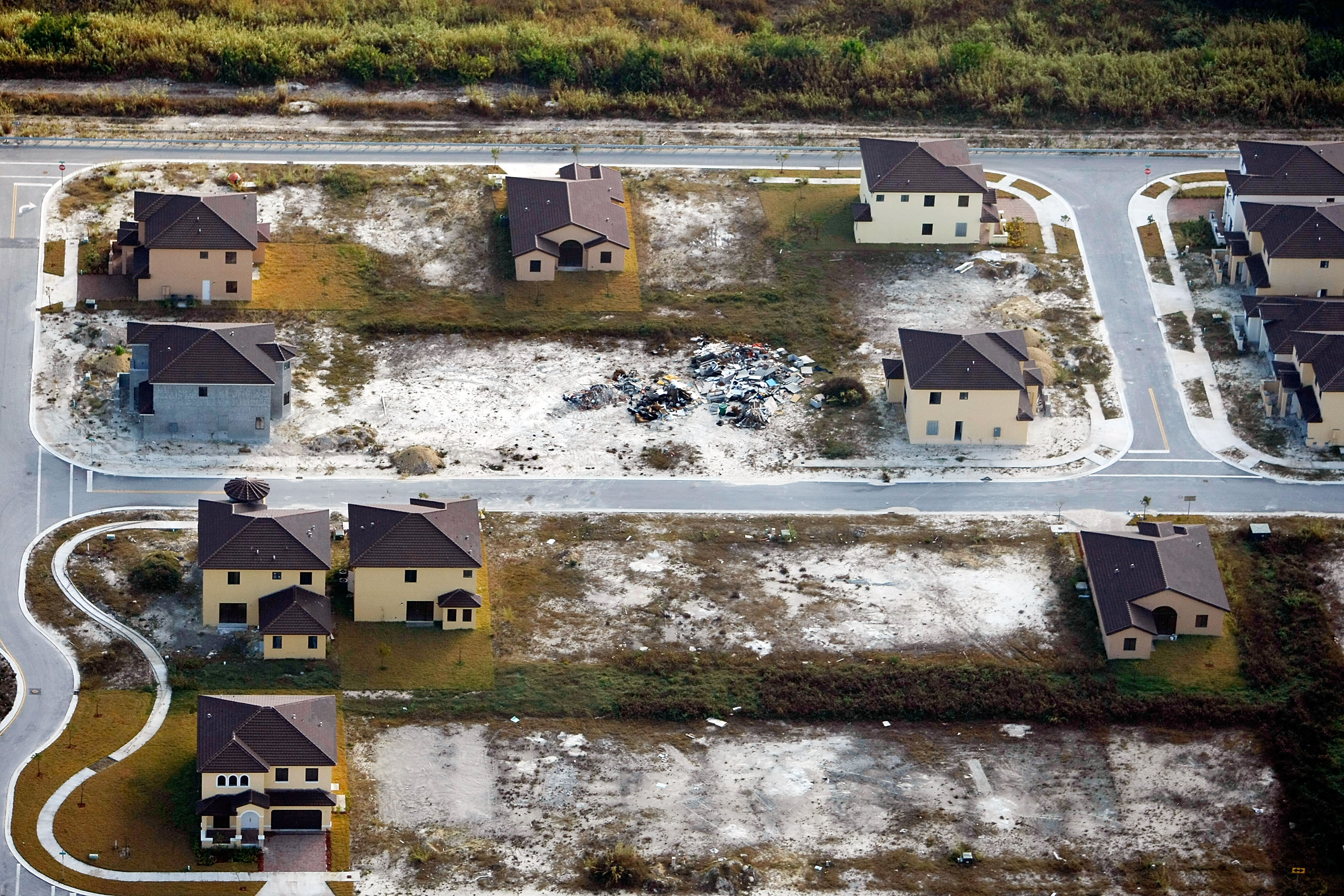 Partly built houses, abandoned homes, and empty lots in a development near Homestead, Florida, in January 2009 provide a stark record of the impact of the oversupply of housing, falling prices, and predatory subprime mortgages during the Great Recession.