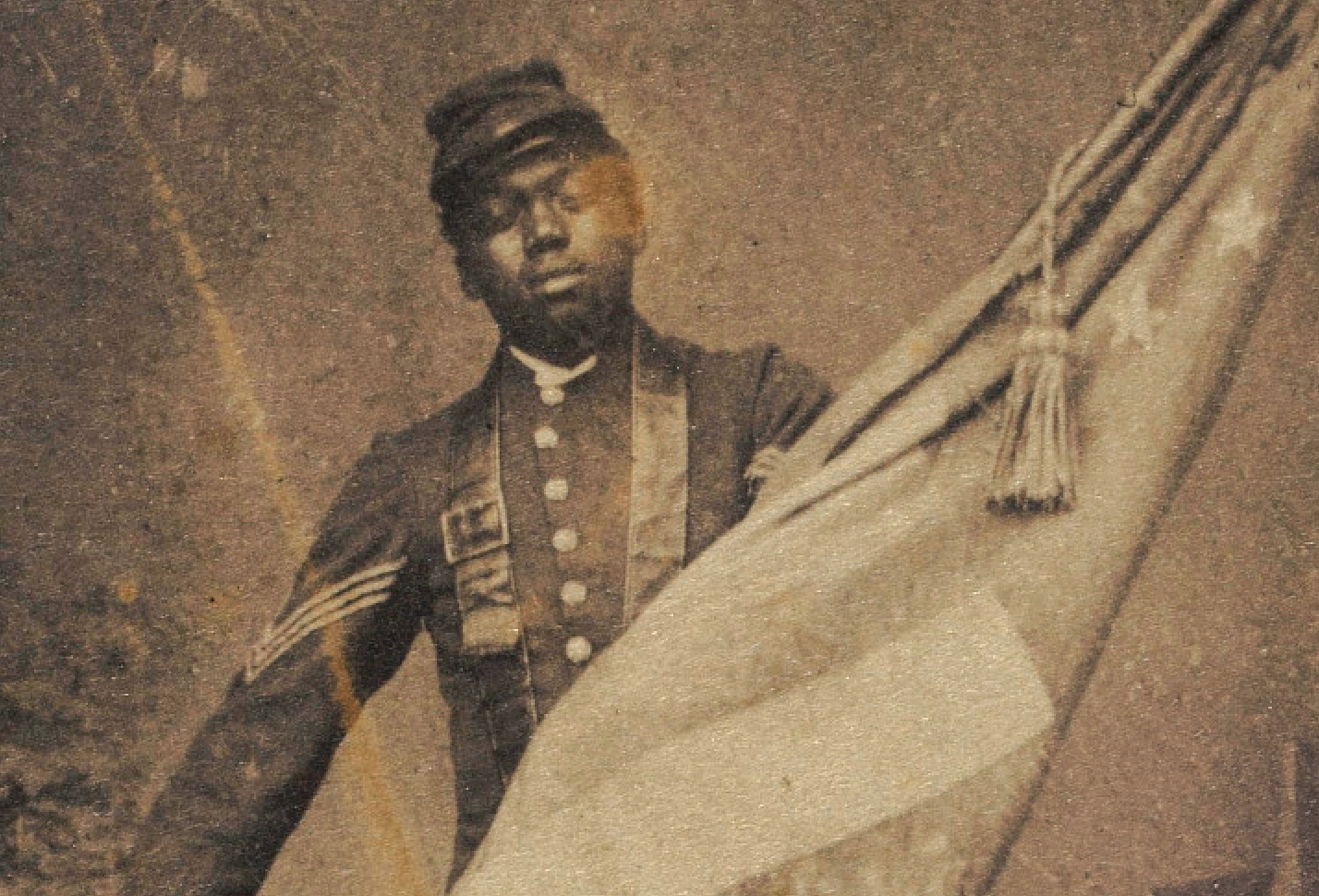 The carte-de-visite photograph of William H. Carney holding the Stars and Stripes operates as a commemorative portrait. Initially denied the right to serve, Black Civil War soldiers fought gallantly on the war front while facing continued discrimination on the home front. This portrait of Carney celebrates his courage in securing and raising the American flag during battle.