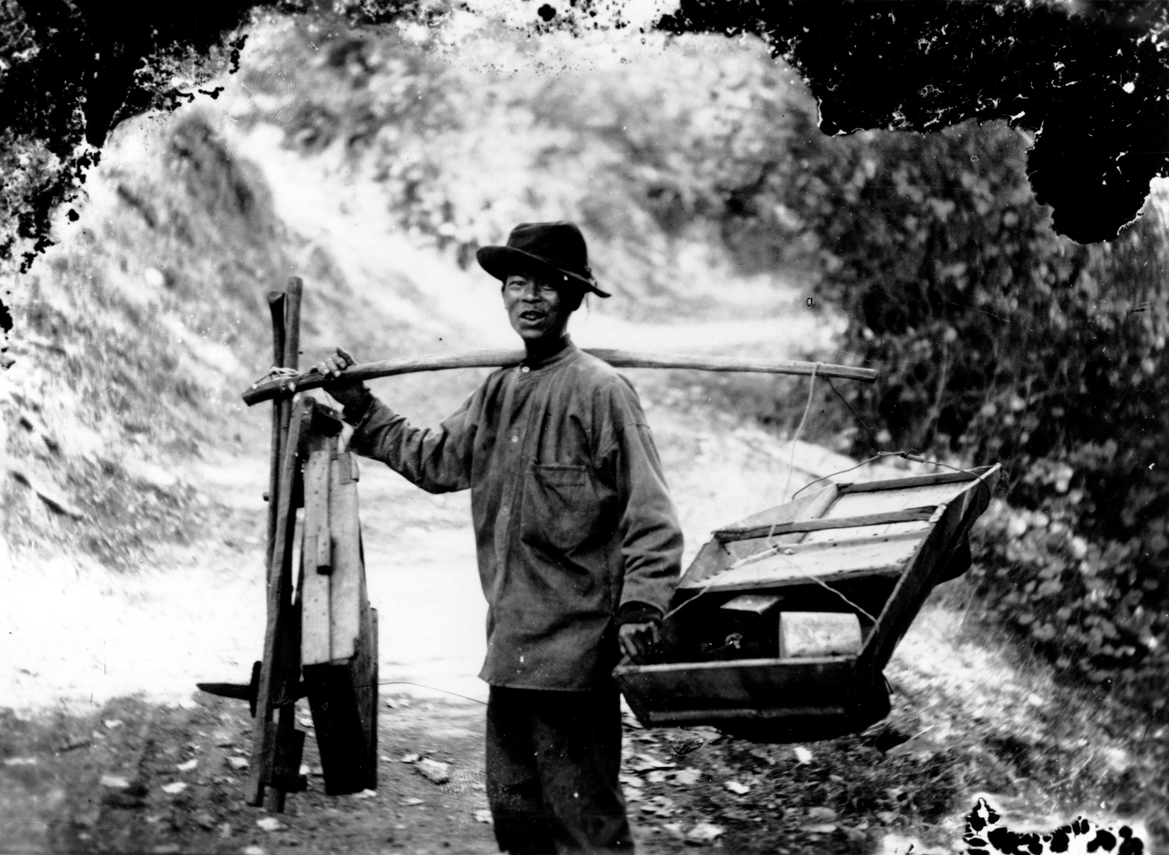 With the aid of a shoulder pole, which derived from his homeland, a Chinese immigrant carried one of the prospector’s essential tools: a rocker box, also known as a cradle. While a sluice box was used in streams to retrieve gold, the rocker box was designed for dry places. Miners poured a small amount of water into the box and then rocked it from side to side until dirt and other materials sifted through its perforated bottom, leaving the heavier gold behind.