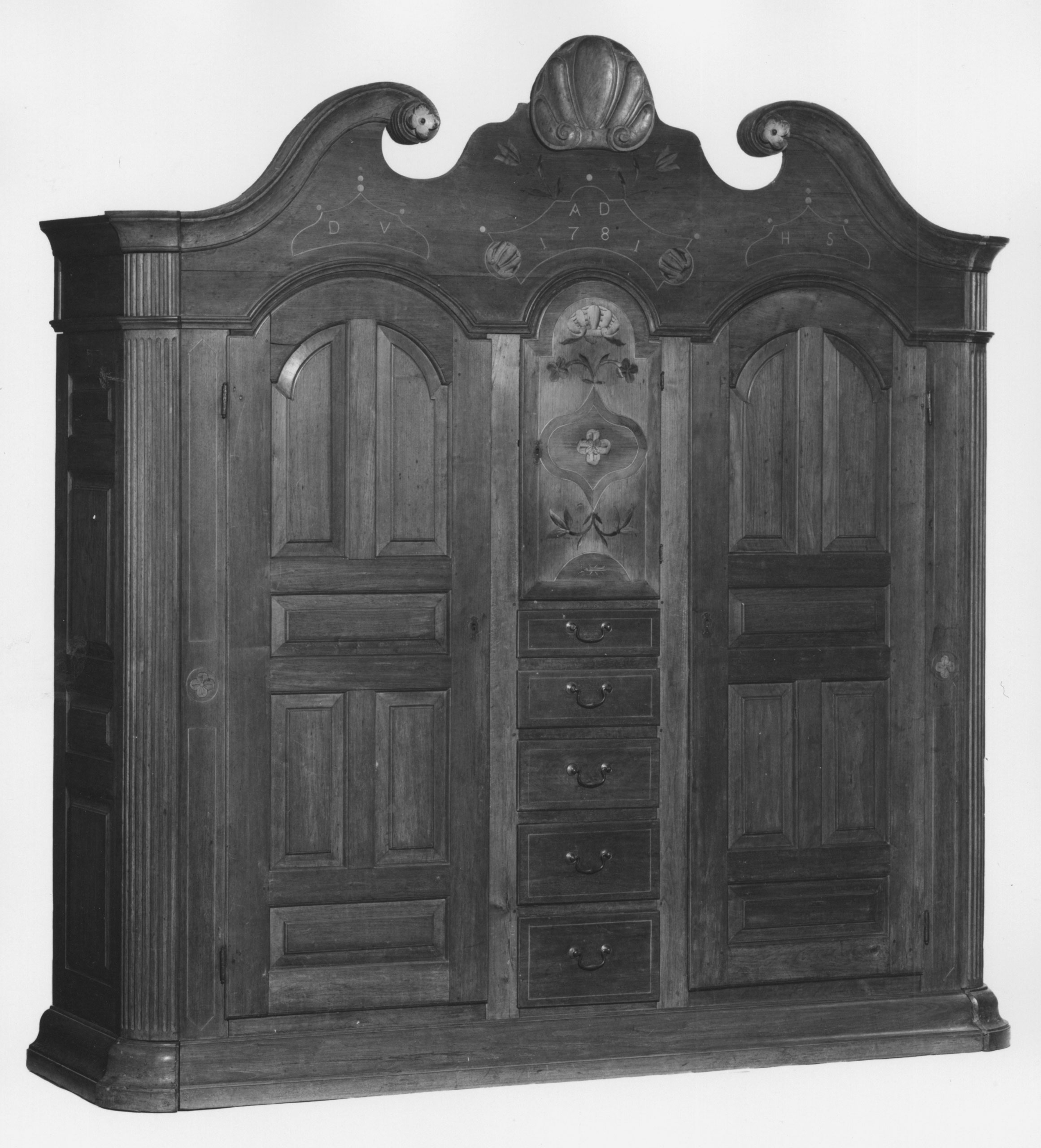 German immigrants formed the largest non-British white community in the colonies by the time of the Revolution. Many managed to balance their German ethnicity and the English culture they encountered—in religious institutions, residential patterns, marriage partners, and the furniture they used every day. David Hottenstein built this wardrobe (or <em>shrank</em> in German) to store clothing and other household items in Berks County, Pennsylvania, in 1781. While the wardrobe’s shape, decoration, and mode of construction were inspired by styles that were common in Germany at the time, Hottenstein added a set of drawers, an English innovation.