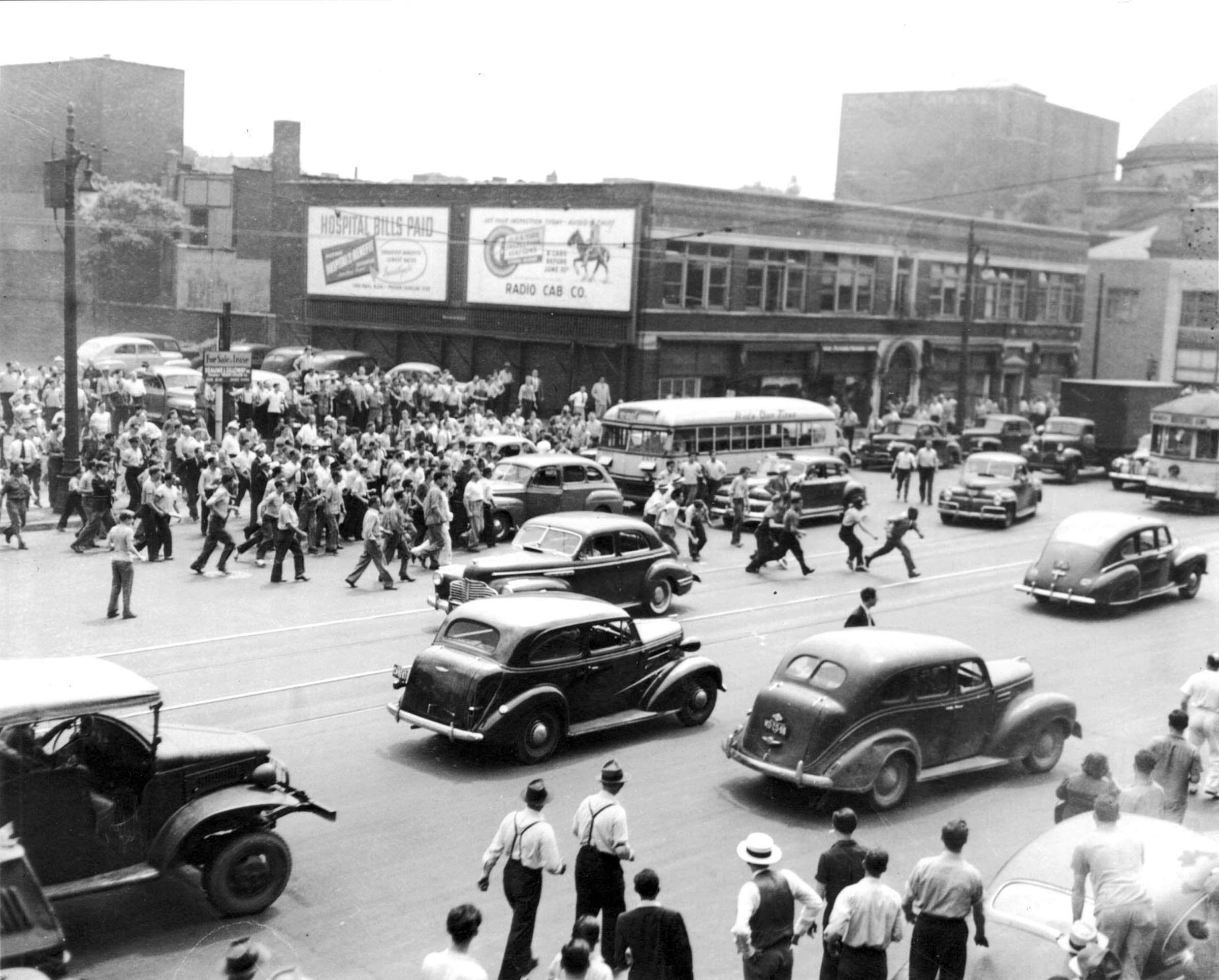 While police stood by, white crowds terrorized African Americans on Detroit’s Woodward Avenue. As shown here, African American motorists were pursued and beaten, and their cars were destroyed. Shortly after this photo was taken, the victim’s car (halted in front of the bus) was overturned and set on fire.