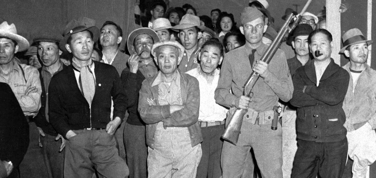 These Japanese Americans in the newly opened California internment camp had gathered to watch the arrival of fellow internees.