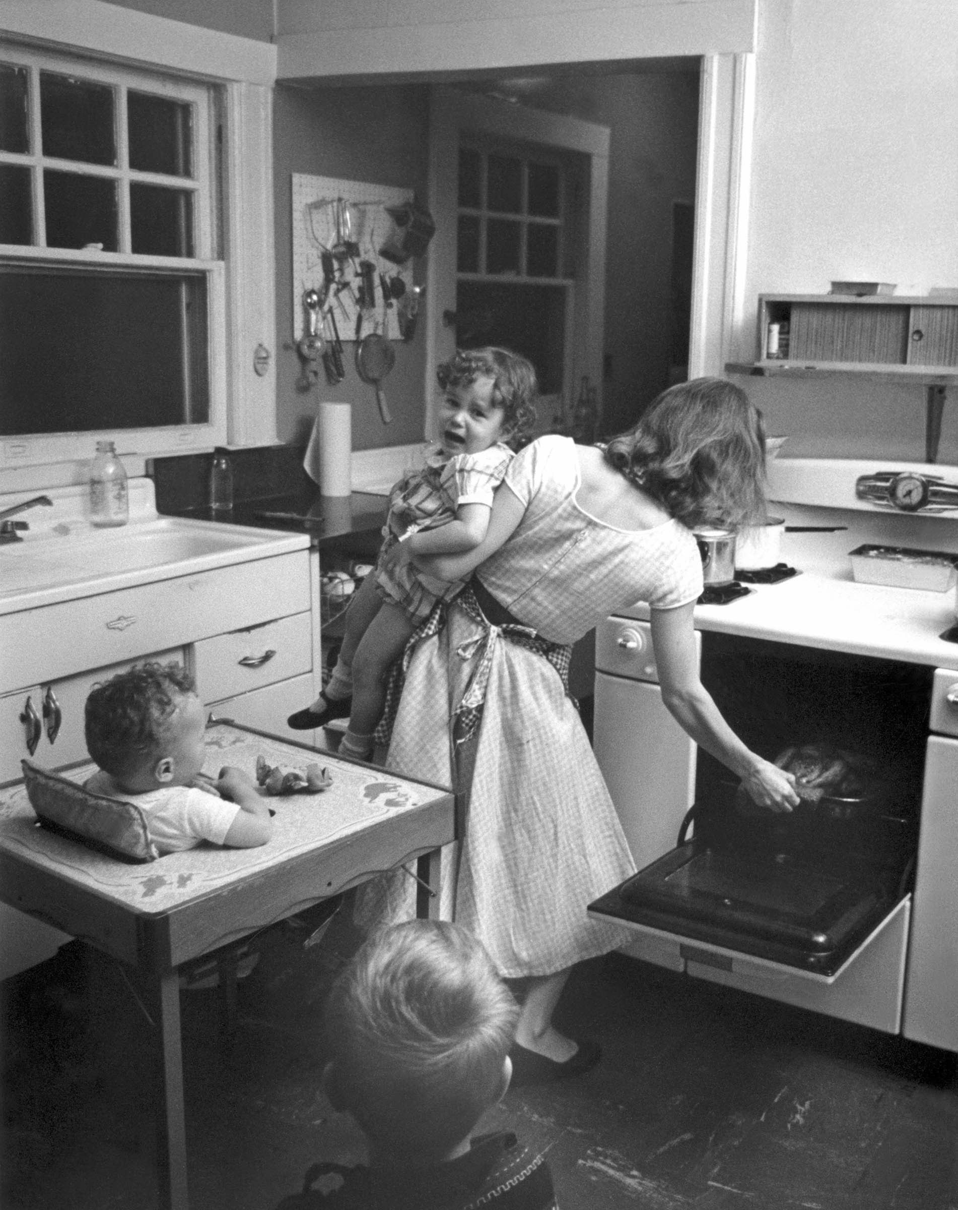 Documentary photographer Elliott Erwitt captured the incessant demands of housework and child care in one New Rochelle, New York, home in 1955.