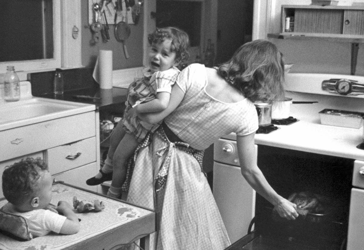 Documentary photographer Elliott Erwitt captured the incessant demands of housework and child care in one New Rochelle, New York, home in 1955.