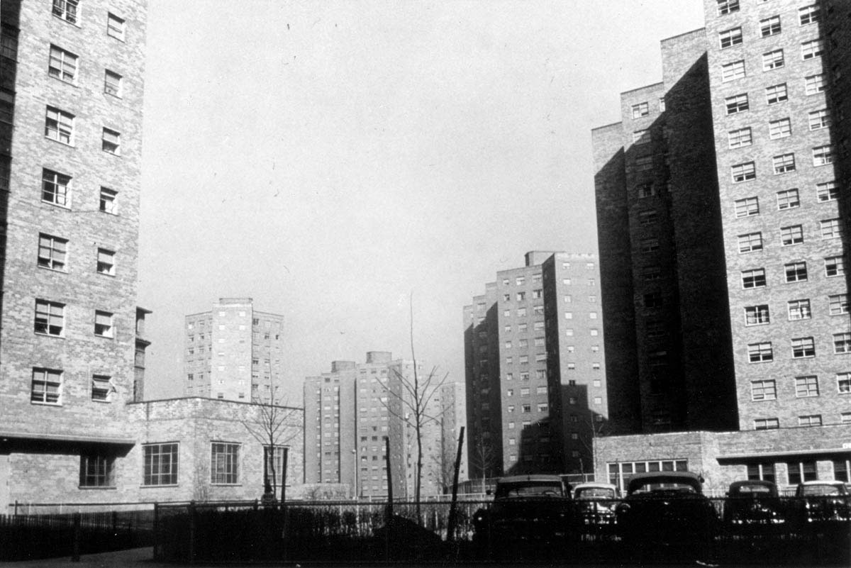 In the years following World War II, as many middle-class families moved to the suburbs, inner-city public housing increasingly became identified with poor Americans. Living in public housing was viewed by many as a stigma, and new high-rise projects took on a harsh and regimented appearance. Pictured here are the George Washington Carver Houses in East Harlem, New York, which were built and maintained by the New York City Housing Authority.