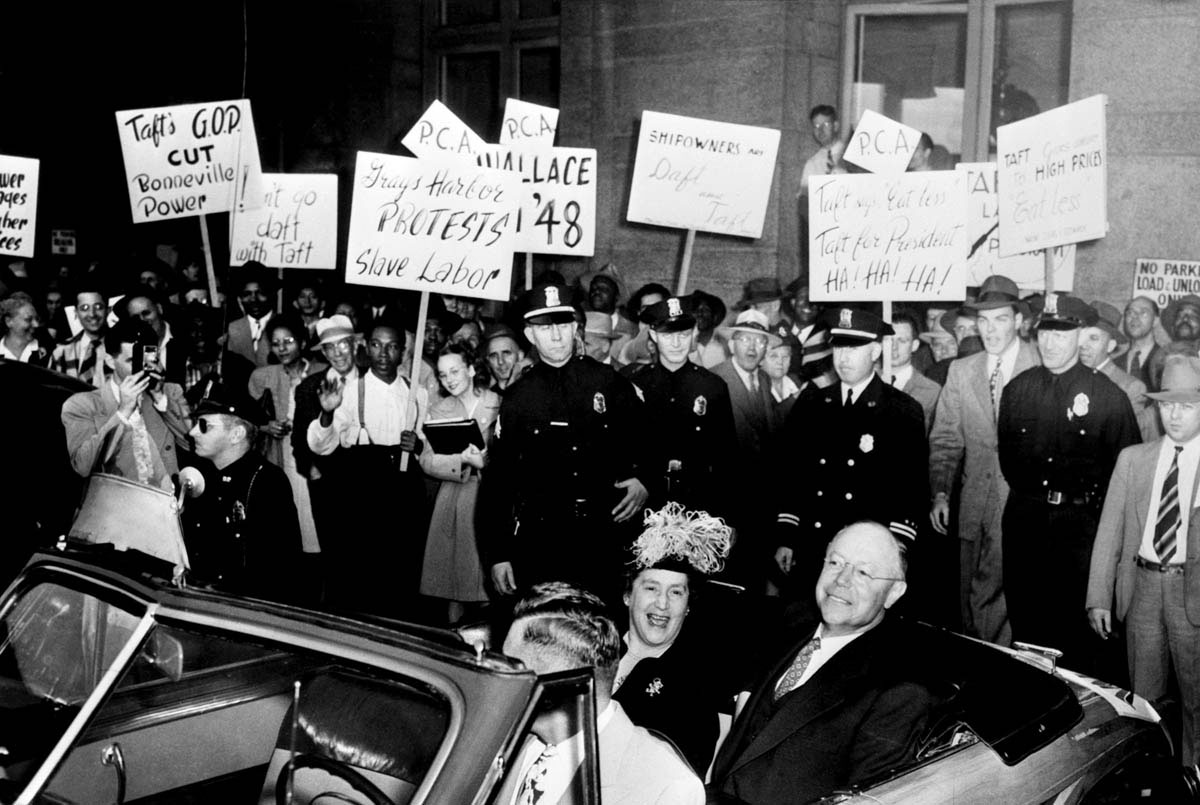 Ohio Republican Senator Robert Taft, cosponsor of the Taft-Hartley Act, is confronted by trade union demonstrators in Seattle, Washington, in August 1947.