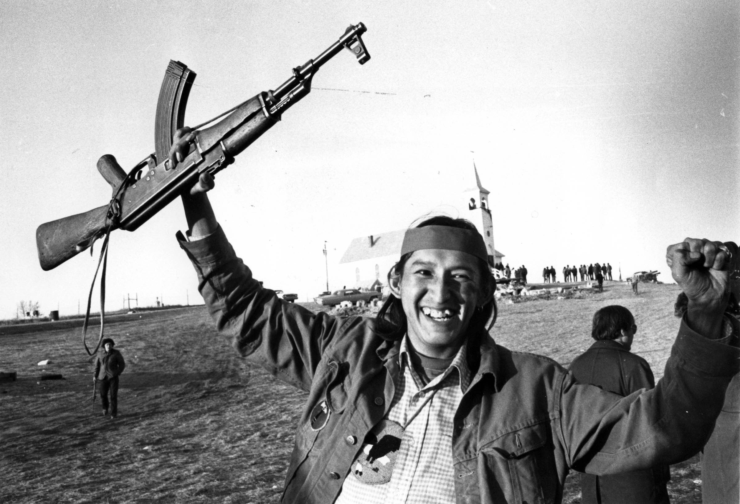 An American Indian Movement (ΑΙΜ) activist rejoices after hearing that the federal government has agreed to a cease-fire and negotiations at the Pine Ridge Reservation in South Dakota. The three-month confrontation between AIM and federal marshals began in February 1973 when AIM seized hostages at a reservation trading post to dramatize their protest against Bureau of Indian Affairs policy and conservative Native leadership.