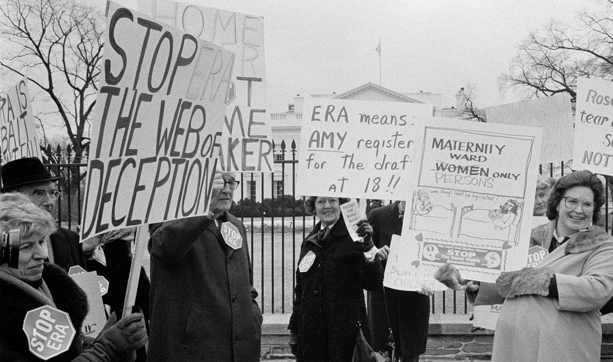 Carrying signs that warned of ways in which the Equal Rights Amendment would purportedly victimize women and that referred to President Carter’s daughter Amy and his wife Rosalynn (both ERA supporters), opponents of the amendment demonstrate in front of the White House in February 1977.