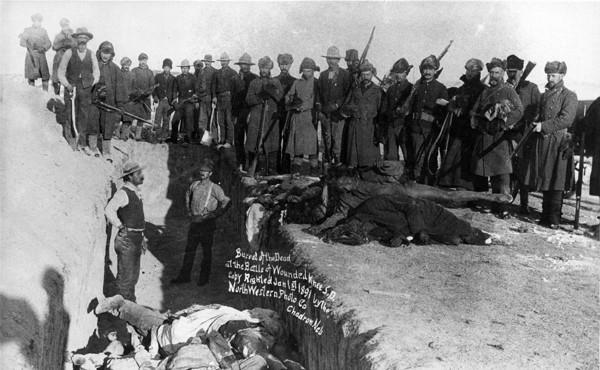 The day after the “battle” of Wounded Knee, the dead Lakotas—estimated by the U.S. Army at 84 men, 44 women, and 18 children—were buried in a mass grave at the scene of the massacre on the Pine Ridge Reservation Agency, South Dakota.