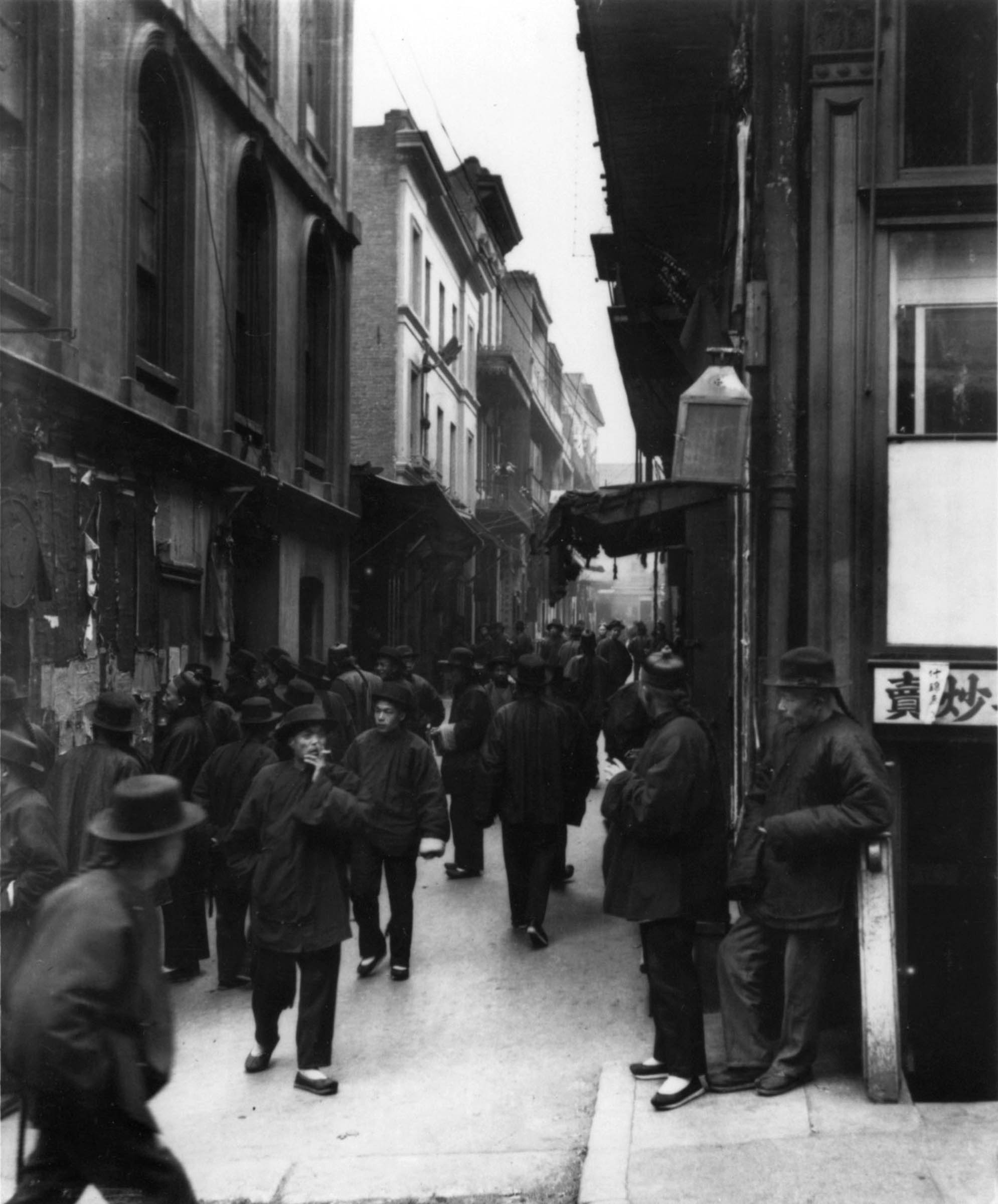 Arnold Genthe’s photographs of San Francisco’s Chinatown provide information about the Chinese community at the turn of the century. His characterization of his subjects, however, often conveys a distorted and ominous message. Despite its title, this photograph of Ross Alley, taken some time around New Year’s, simply depicts the unusual daytime congestion resulting from the seasonal unemployment of many Chinatown workers after the holiday.