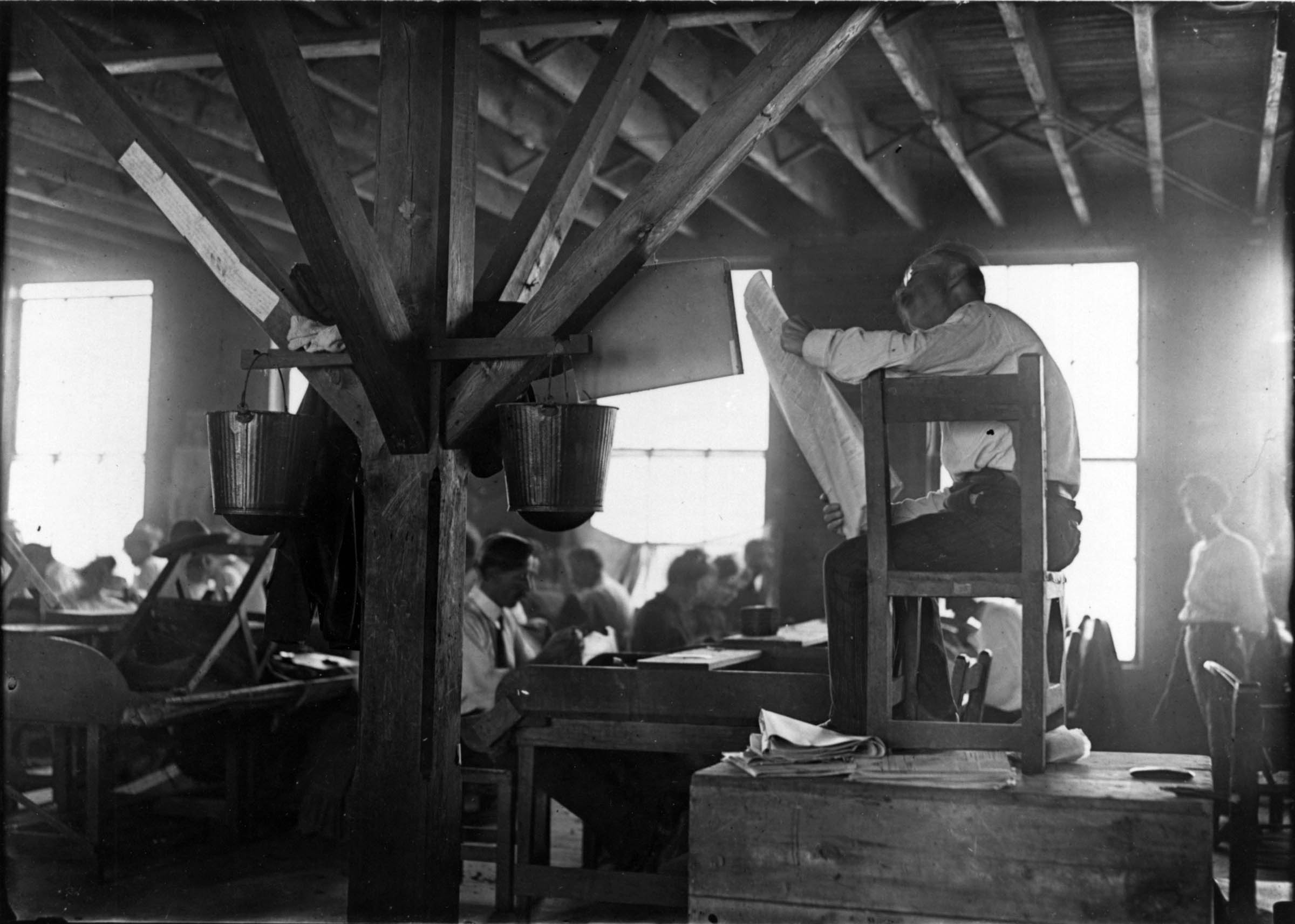 While his fellow workers make cigars, one craftsman reads aloud from a newspaper. This arrangement, in which cigar makers pooled their wages to cover the pay of the designated reader, indicates how some skilled trades maintained preindustrial customs even as their work became subdivided and mechanized.