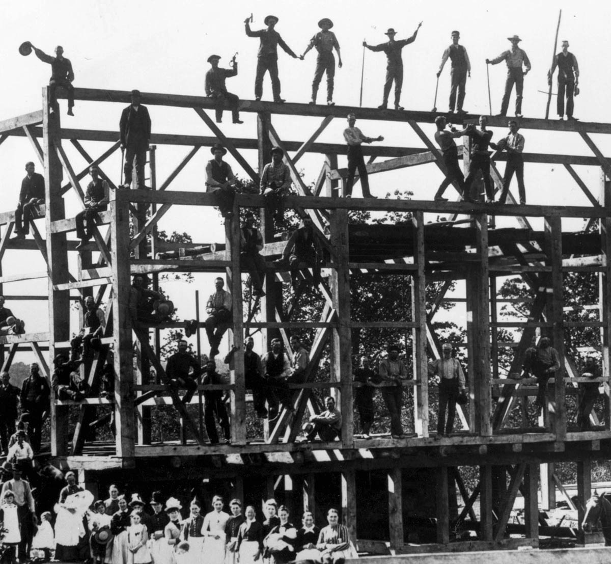 Survival in rural America often relied on community support. Jacob Roher and his neighbors took a break from their construction efforts on his farm near Massillon, Ohio, in 1888 to pose for a photographer.