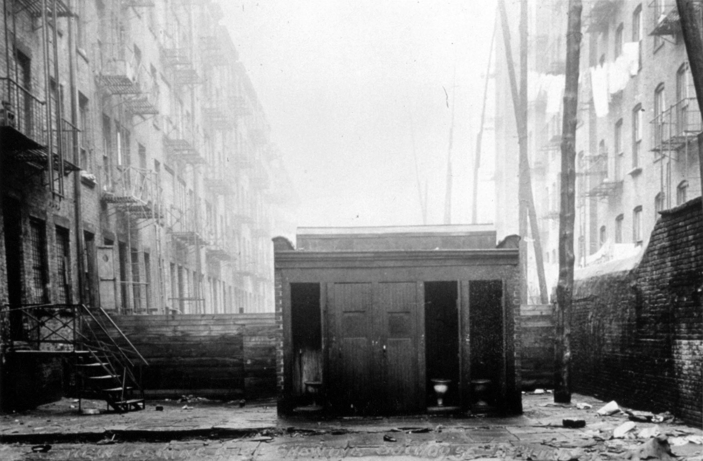 Toilet facilities, such as this backyard outhouse, remained minimal in some immigrant urban neighborhoods.