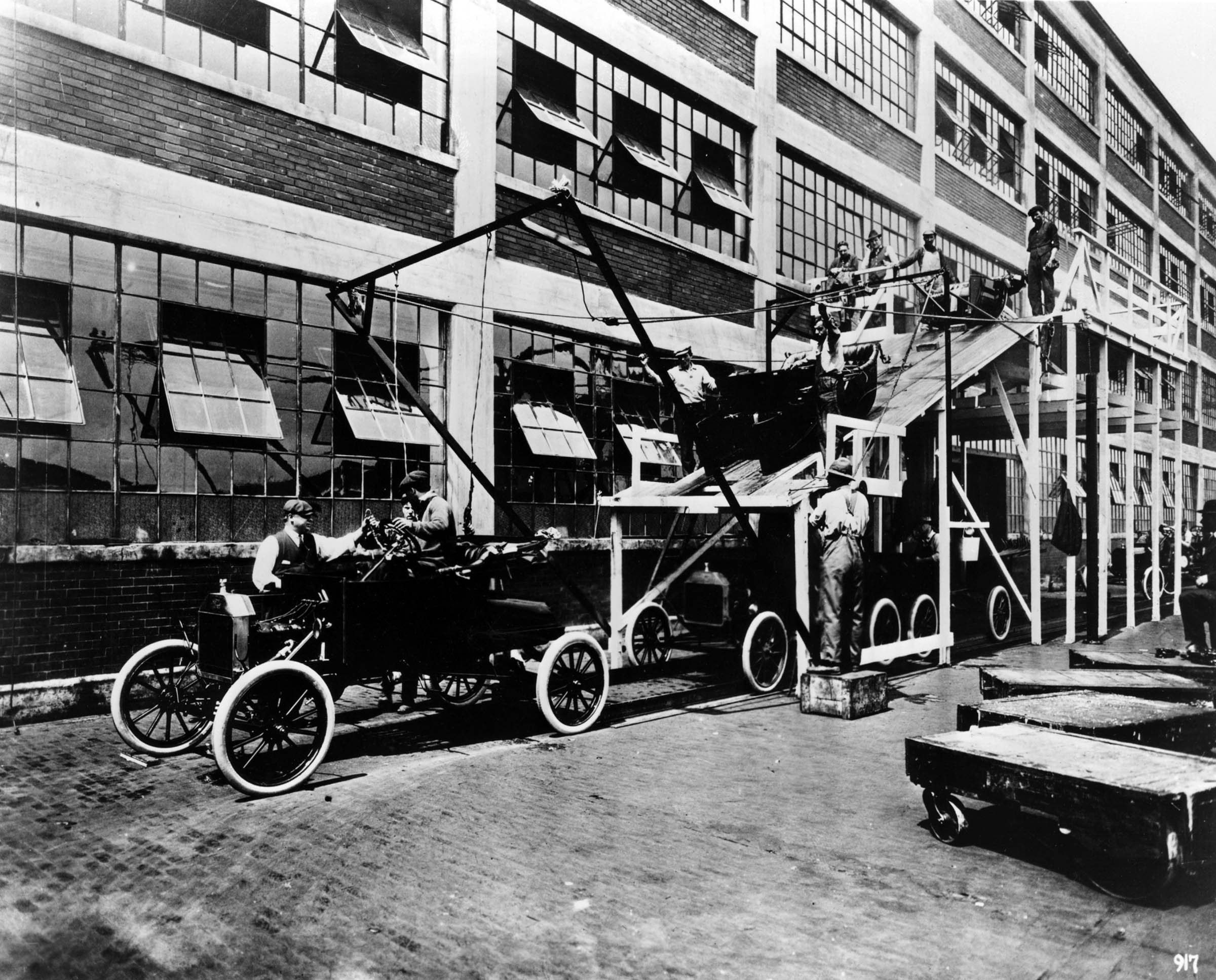 The Ford assembly line in Highland Park, Michigan, was a prime example of continuous-process production. In this photo, taken in 1913, automobile bodies are secured to chassis.