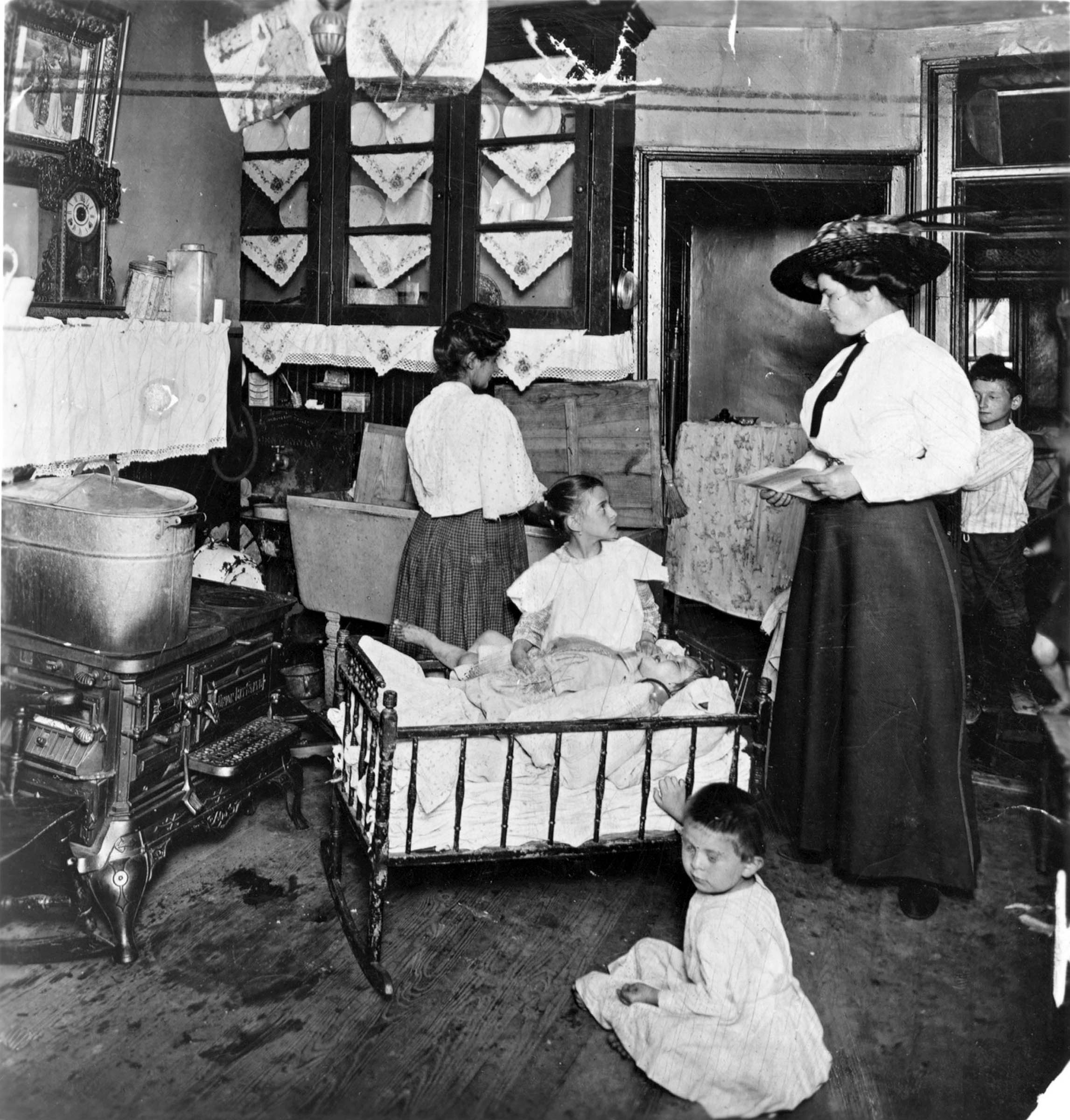 This photograph documenting the activities of a settlement-house worker captures the complicated relationship between reformers and the people they “served.” The reformers’ altruism was offset by their belief in the superiority of middle-class mores, which they imposed on immigrants to get them to relinquish “un-American” customs.