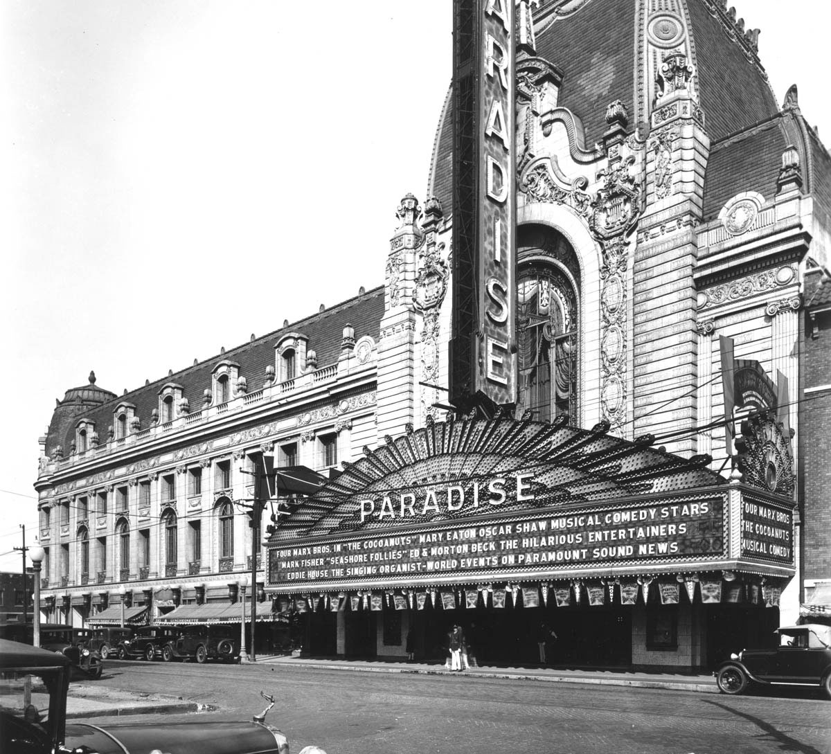 Designed by renowned architect John Eberson, the Chicago Paradise, which opened in 1928, &nbsp;was one of the grandest of the new movie palaces. Dubbed “the World’s Most Beautiful Theater” by Chicago theater entrepreneurs Balaban and Katz, the Paradise had a half-block-long French-inspired Second Empire exterior, featuring a marquee emblazoned with more than 10,000 light bulbs and a seven-story entrance tower. Patrons entered an outer lobby that had a soaring domed ceiling painted with constellations and clouds. In the vast auditorium, a sculpture of three horses pulling a chariot was set above the proscenium arch, appearing to gallop towards the audience.