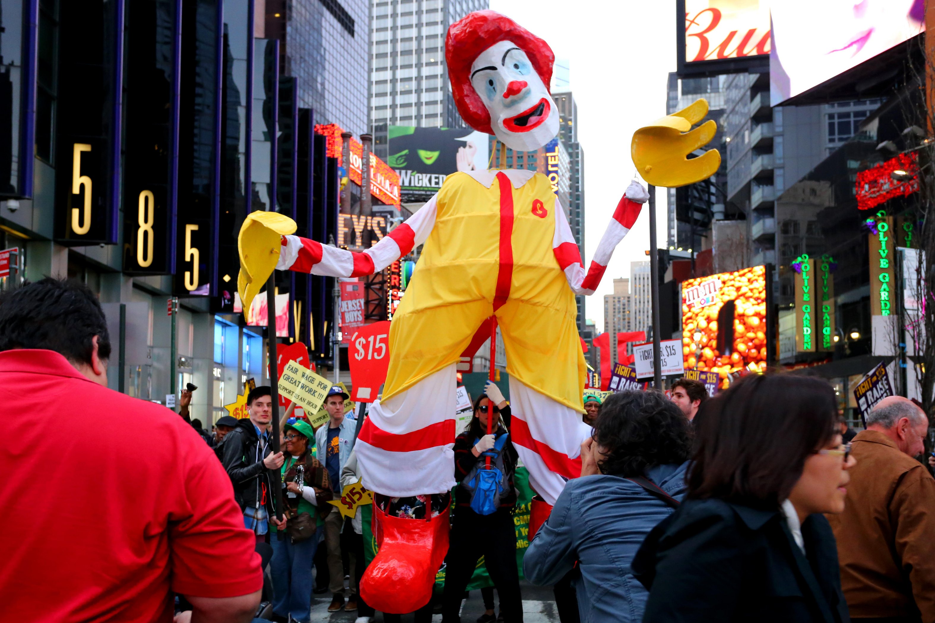 Twisting the fast-food giant McDonald’s “I’m Lovin’ It” slogan into a demand for fair pay, fast-food workers chanted “Fight for ” as they marched in New York’s Times Square, carrying a grotesque version of the corporation’s clown mascot (a parody of the familiar Macy’s Thanksgiving Day parade balloon). The April 2015 demonstration joined hundreds of “living wage” protests across the country—and the globe—that year.