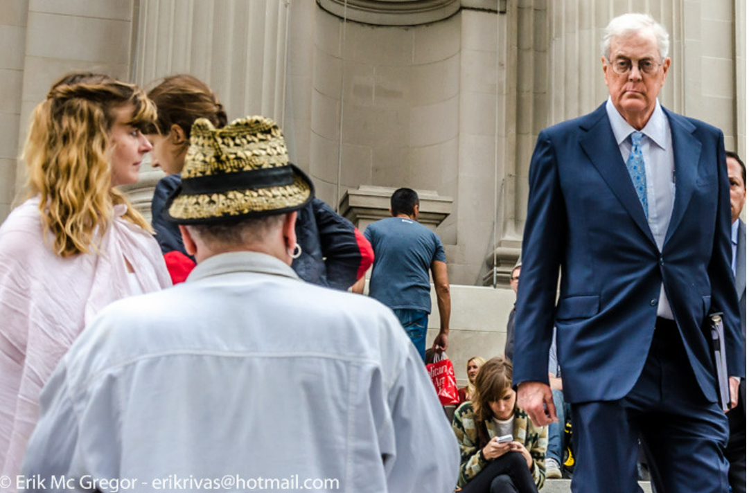 In September 2014, energy magnate David H. Koch passed by protesters on the Metropolitan Museum of Art’s plaza, which had been recently renamed in his honor. The demonstration, held by Occupy Museums, denounced the Met’s involvement with Koch, who underwrote the full  million cost of the redesign and renovation of the plaza fronting New York’s premier art institution. One of the owners of the largest privately run energy company in the United States, Koch and his brother Charles financed for decades deregulation, anti-government, and anti-union candidates, legislation, and movements such as the Tea Party. Along with other giant businesses and corporations, the Kochs masked their business practices and political influence through philanthropy, especially in heavily publicized donations to major cultural institutions.