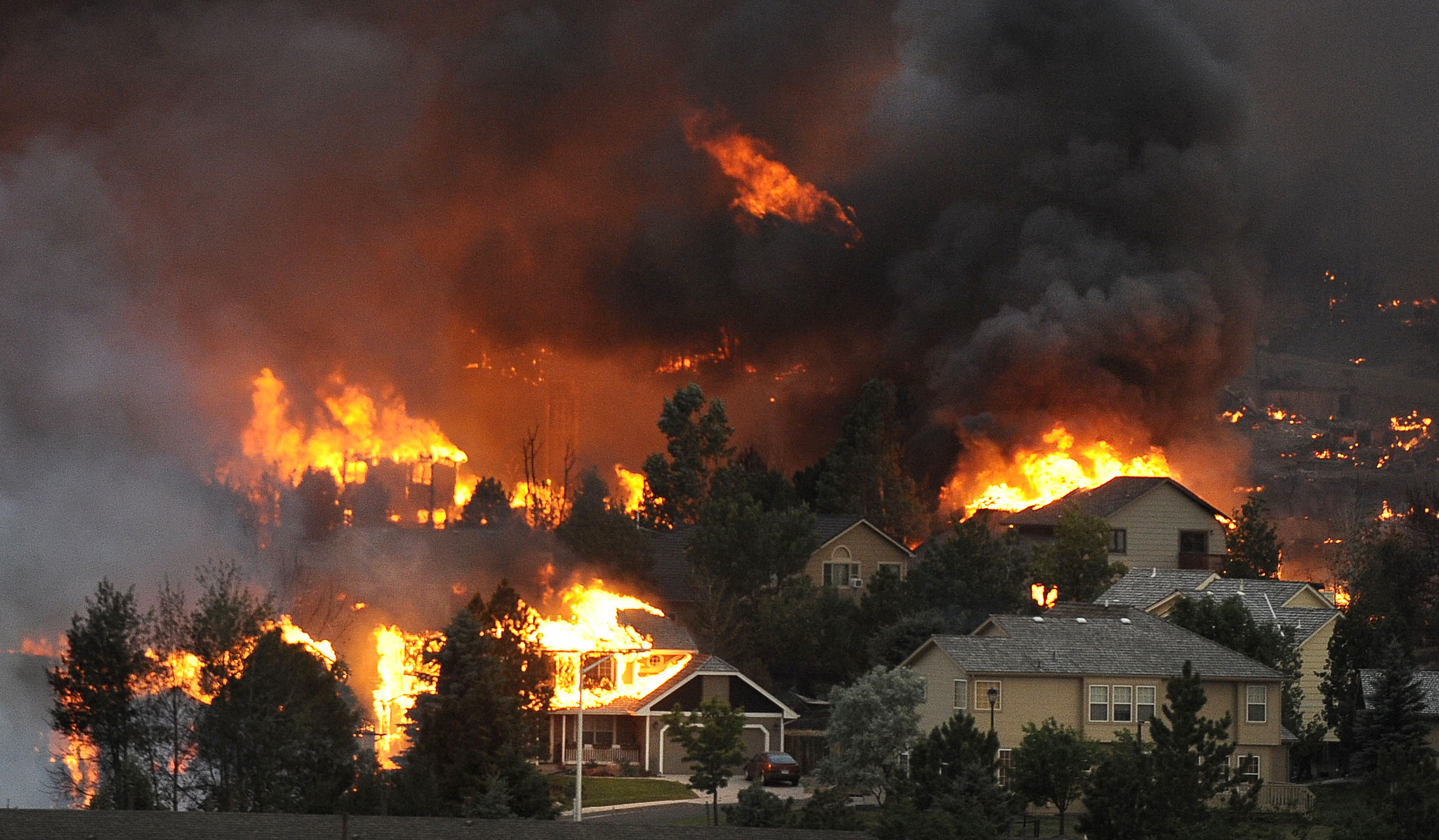 During the Waldo Canyon fire in Colorado in June 2012, the Mountain Shadows neighborhood was engulfed in flames; 347 homes were destroyed and thirty-two thousand residents evacuated in a year that saw, statewide, 4,167 wildfires that destroyed 384,803 acres and caused six deaths. Worldwide and in the western United States, wildfires have grown in intensity and frequency, doubling in number in the U.S. between 1984 and 2015. Previously more prevalent during summer, wildfire season now begins earlier and ends later each year due to increased heat waves and droughts caused by climate change, itself the result of human activity.